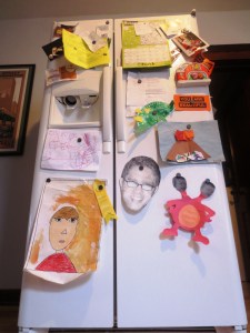 This refrigerator is in danger of toppling over with the weight of family artwork.